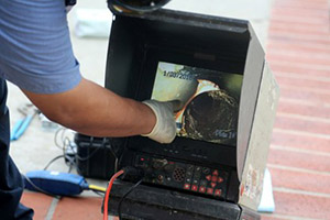 Professional drain cleaning equipment being used